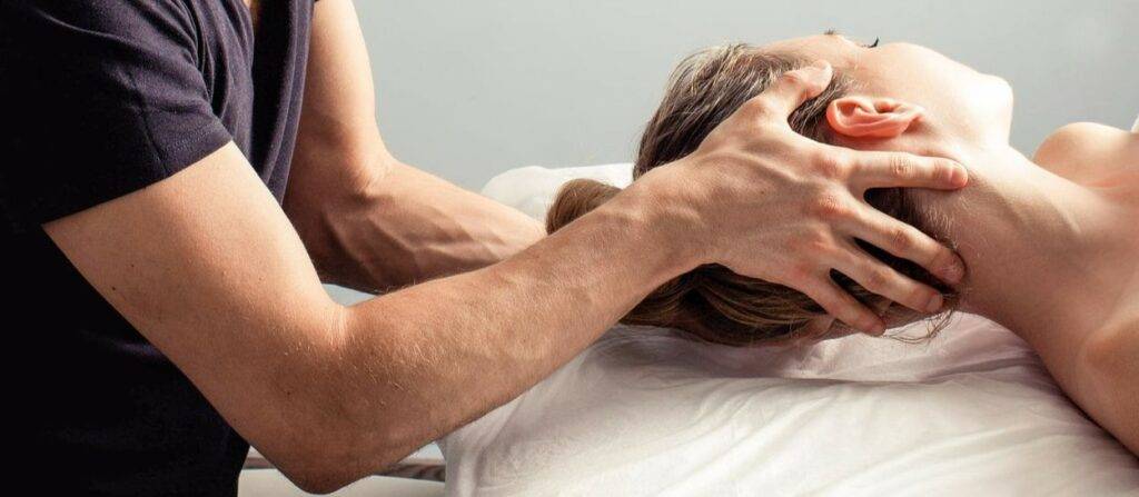 Man turning womans head with cervical rotation