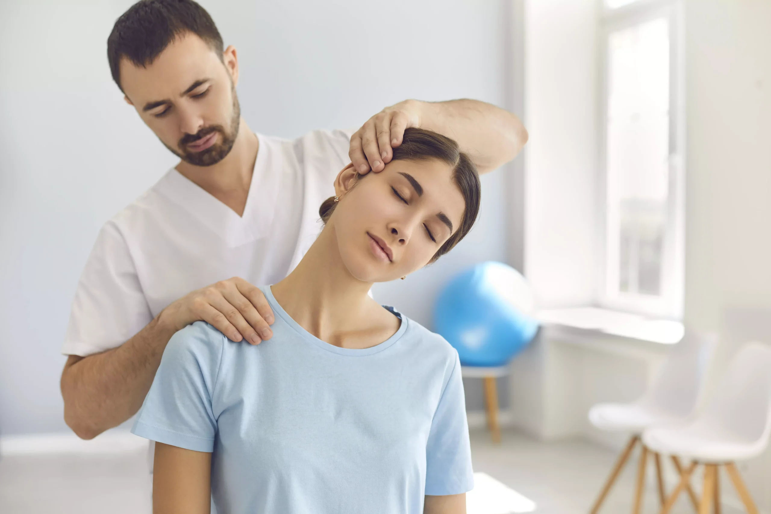 Massage therapist stretching a womans neck